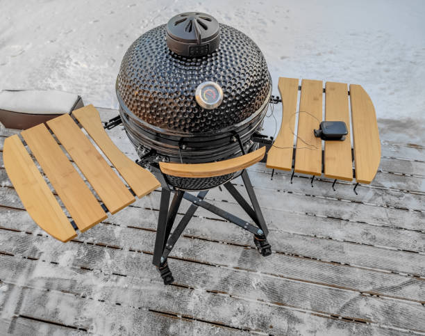 istock Large kamado type barbeque grill with a thermometer standing on a terrace in winter 1365006240