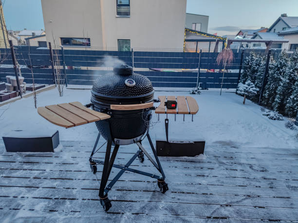 istock Large kamado type barbeque grill with with smoke coming from a chimney 1365006264