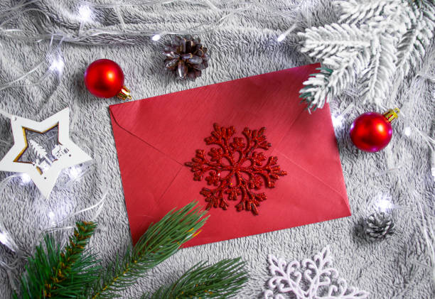 istock envelope, christmas tree branch, alarm clock christmas background 1365006428