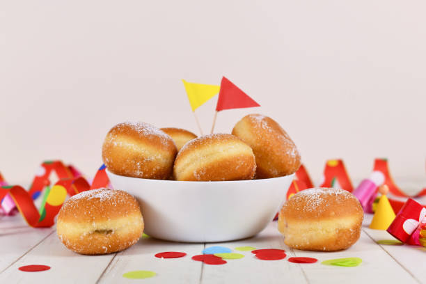 Baked pastry doughnuts Krapfen for carnival Fasching celebration with streamers and confetti