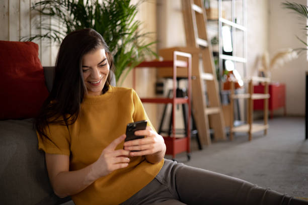 istock Happy Caucasian woman using a smart phone at home 1365010578