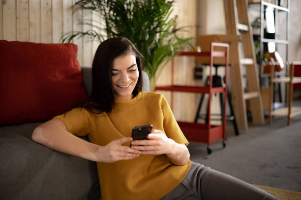 istock Happy Caucasian woman using a smart phone at home 1365010579