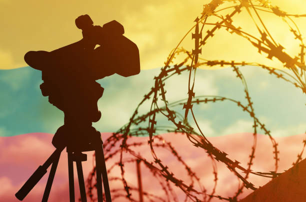 istock Double exposure - camera, barbed wire and flag Lithuania 1365011526