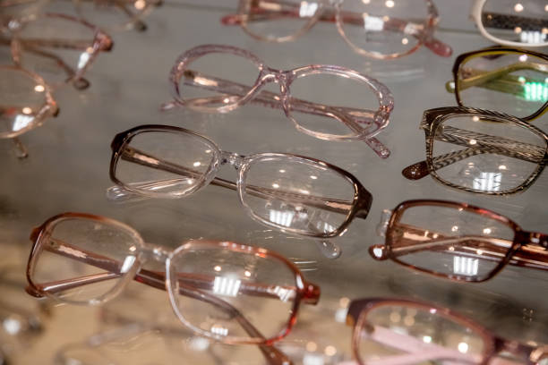 istock Many glasses rows at optical retail store. Rich assortment choice of different eyewear frames on eyeglasses shop display.optical shop.Row with colorful modern eyeglasses.Selective focus. 1365011687