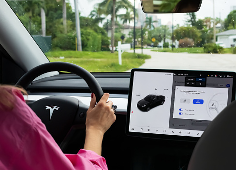 Miami, FL, United States - September 13, 2021: A cockpit with LCD touch screen of electric car Tesla Model Y during drive in Miami, USA. Tesla electric cars are produced by Tesla Motors, Inc. in California, USA.