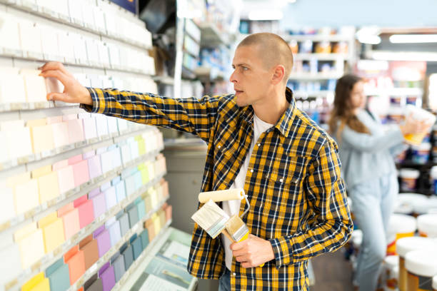 istock Young male customer choosing paint color for renovation works 1365013074