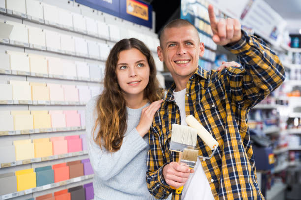 istock Married couple points to something in hardware store 1365013139