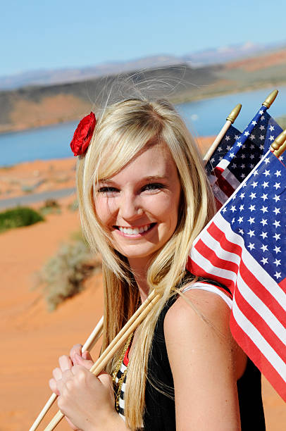 istock Portrait Young Woman Holding Several  American Flags 136501358