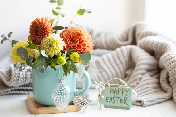 istock Easter composition with a bouquet of flowers and a knitted element. 1365014766