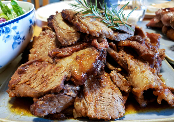 Succulent roasted beef brisket, sliced and placed on a serving plate.