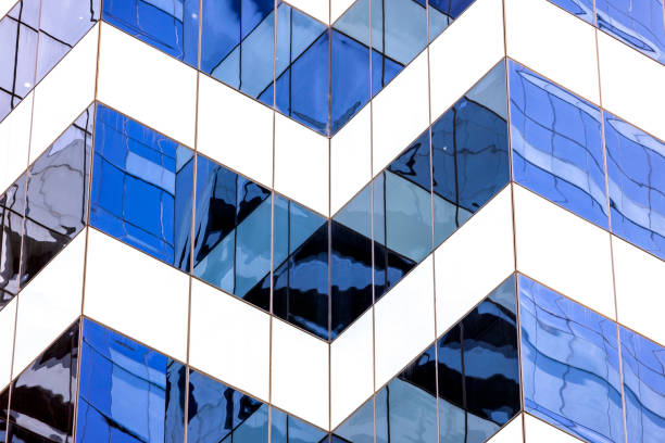 Closeup modern office building with reflection, abstract background with copy space, full frame horizontal composition