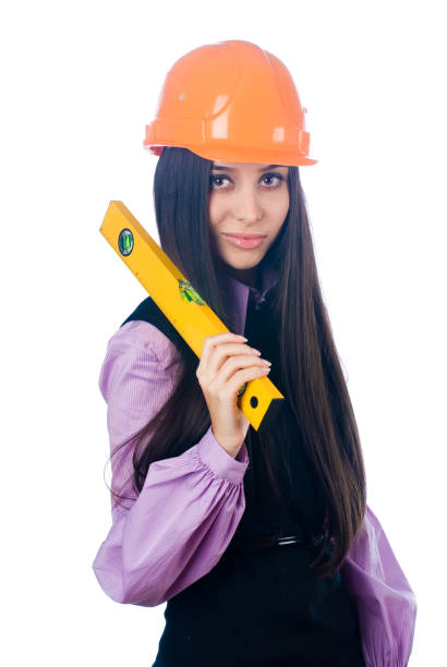 istock Attractive girl in helmet with level tool over white 1365015823