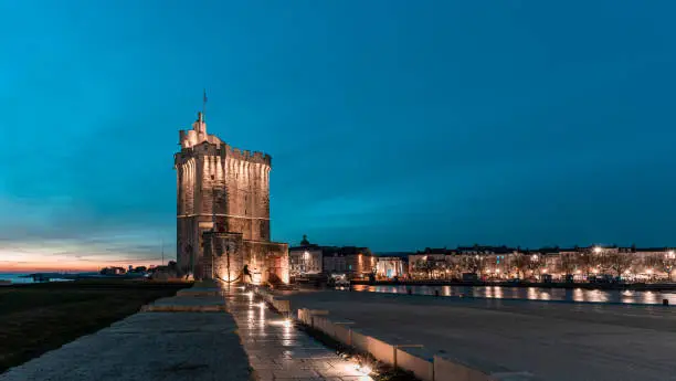 Saint Nicolas tower, one of the famous tower in the old harbour of La Rochelle at blue hour