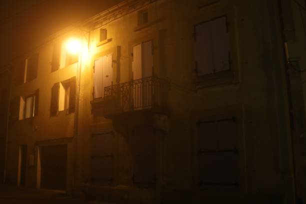 istock Typical village street in the mist at night 1365016908