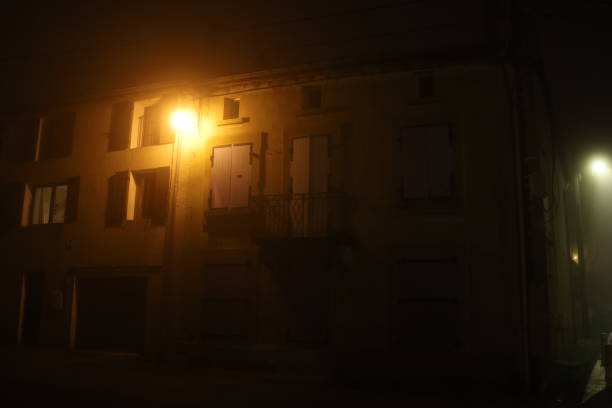 istock Typical village street in the mist at night 1365016909