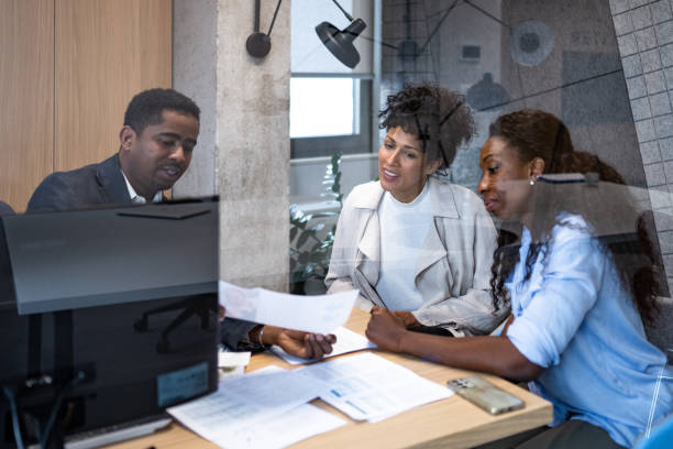 istock Financial advisor talking with female clients 1365020905