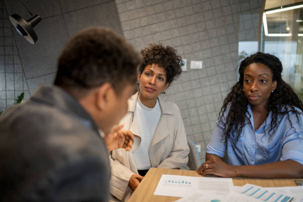 istock Financial advisor talking with female clients 1365020947