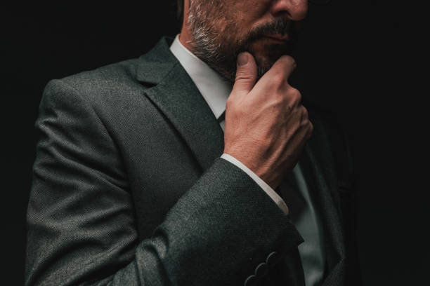 istock Consideration before starting a business, elegant businessman in gray suit thinking and planning 1365025764