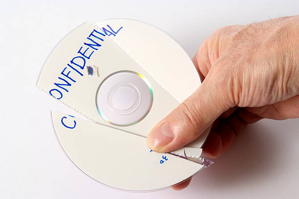 istock Holding a shredded confidential CD on white background 136502593