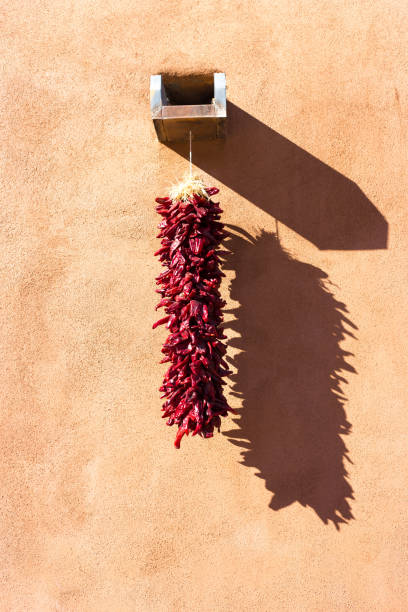 istock Santa Fe, NM: Chili Ristra Hanging on Adobe Wall, Midday 1365027657
