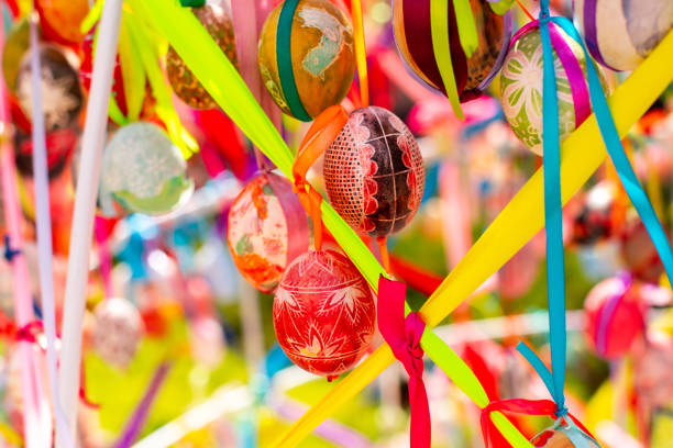 istock A composition of colorful Easter eggs handing with the multi colored ribbons. A bright sunny photo 1365030318