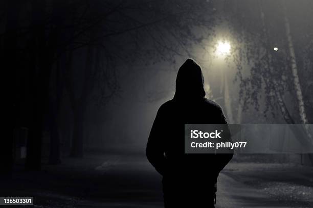 Silhouette Of Hooded Person With Spooky Dark Background Stock Photo - Download Image Now