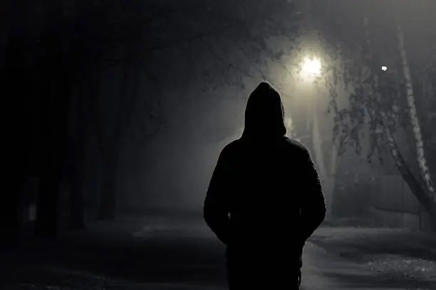 Stranger walking the streets on a cold foggy night