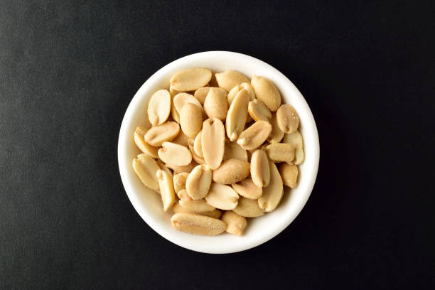 istock Top View of Salted Peanuts in Bowl on Dark Background 1365033328