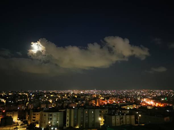 istock The cloudy moon over the city 1365033593