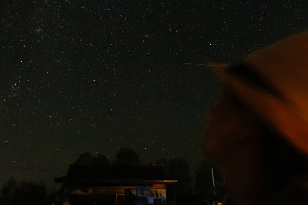 Photo of Defocus beautiful night sky. People looking on shooting star. St