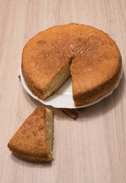 istock Spongy yogurt cake with a cut portion on a wooden table 1365038918