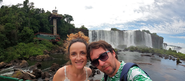 Couple taking a selfie at `Iguaçu Falls` on the Brazilian border