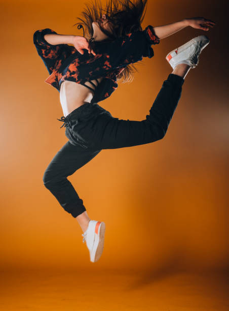 istock Athletic contemporary dancer isolated on orange wall 1365040076