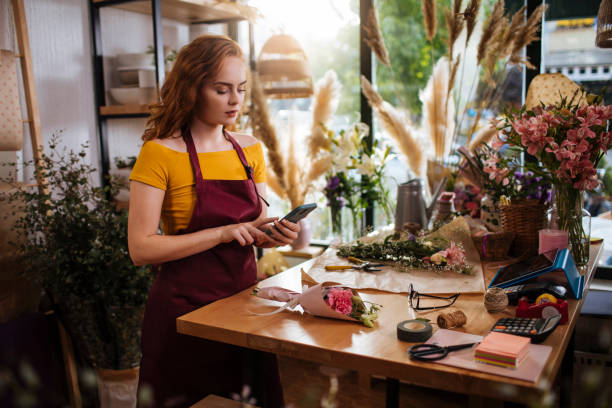istock Taking her flower shop online 1365040183