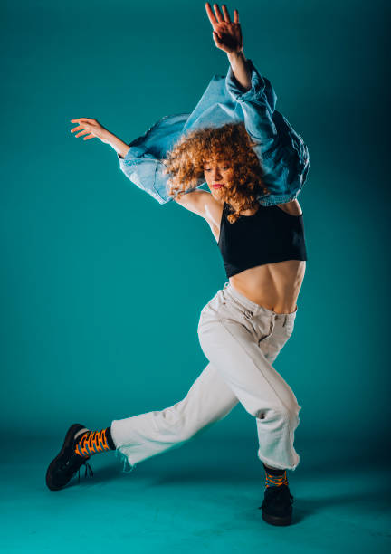 istock Artistic modern dancer on cyan wall 1365040591