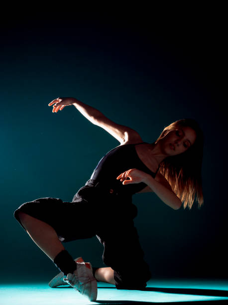 istock Stylish dance artist posing against dark backgorund 1365040623