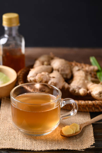 istock Ginger tea with lime and honey on wooden background 1365046084