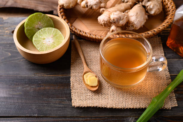 istock Ginger tea with lime and honey on wooden background 1365046141