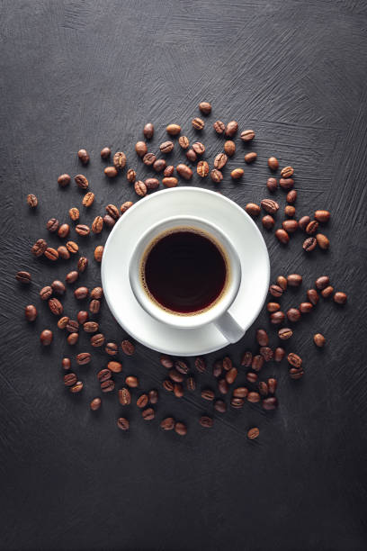 istock Coffe cup with saucer and beans 1365046360