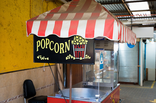 Old popcorn stand at empty market. Pandemic crisis, business lockdown concept, vintage style