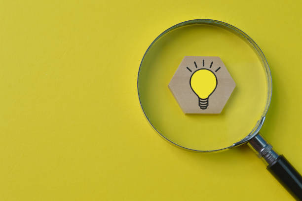 istock Wooden hexagon with light bulb symbol. Idea and brainstorming concept. 1365051801
