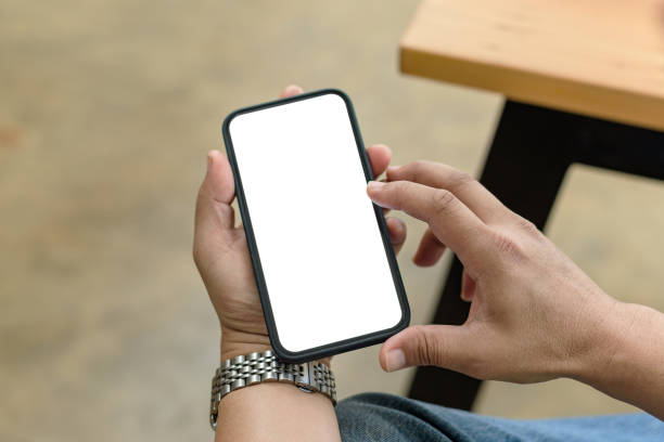 istock Close up. Man hands holding smartphone blank white screen for text message or information. 1365053816