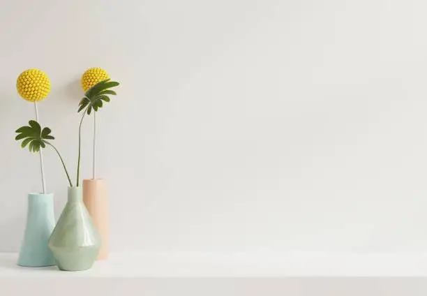 Photo of Mockup white wall with flower vase on Shelf.