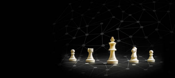istock Leader white king chess figure and dot with digital link line with team beside on dark background 1365055813