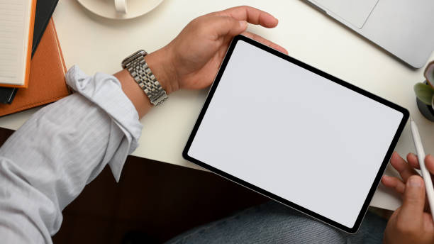 istock A man uses a stylus pen to draw on a tablet screen. 1365059105
