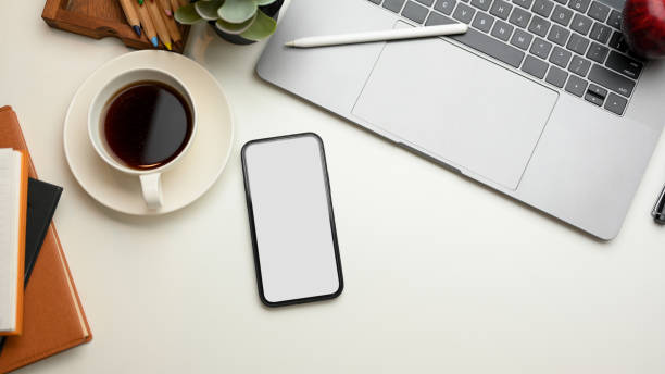 istock Modern workspace with office supplies and smartphone mockup. 1365059106