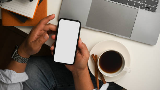 istock Businessman or male freelancer is using smartphone at table. 1365059121