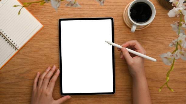 istock Top view, a female's hand drawing on digital tablet. 1365059149