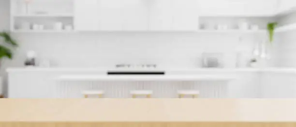 Photo of Wooden kitchen countertop with copy space over white kitchen background.