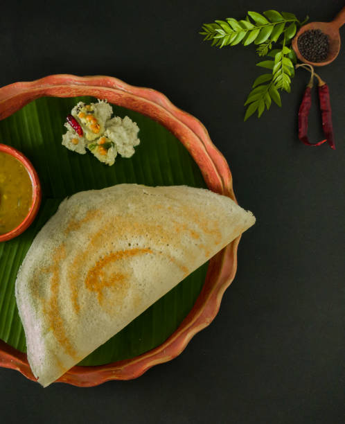 traditional south indian food masala dosa, sambar and coconut chutney served on clay plate and banana leaf. studio shot. - dosa imagens e fotografias de stock